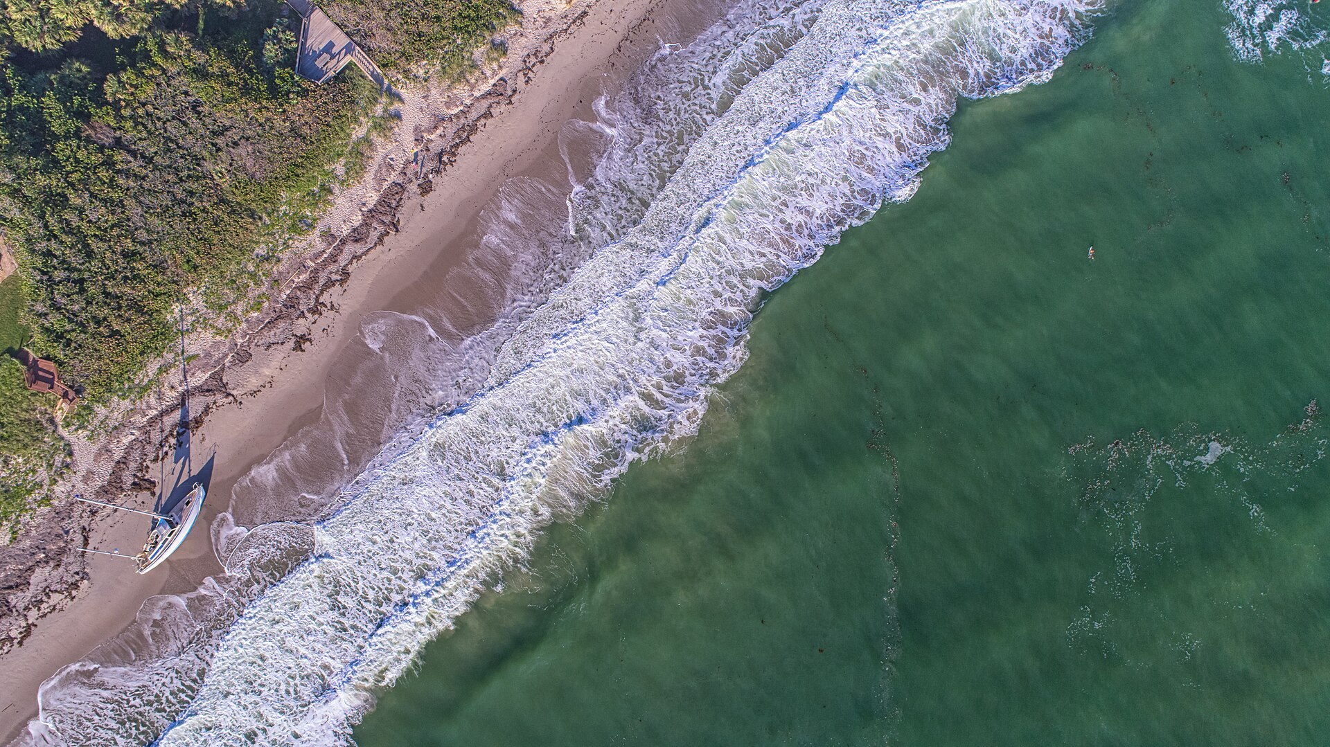 Aerial view of the shoreline and surf in Melbourne Beach